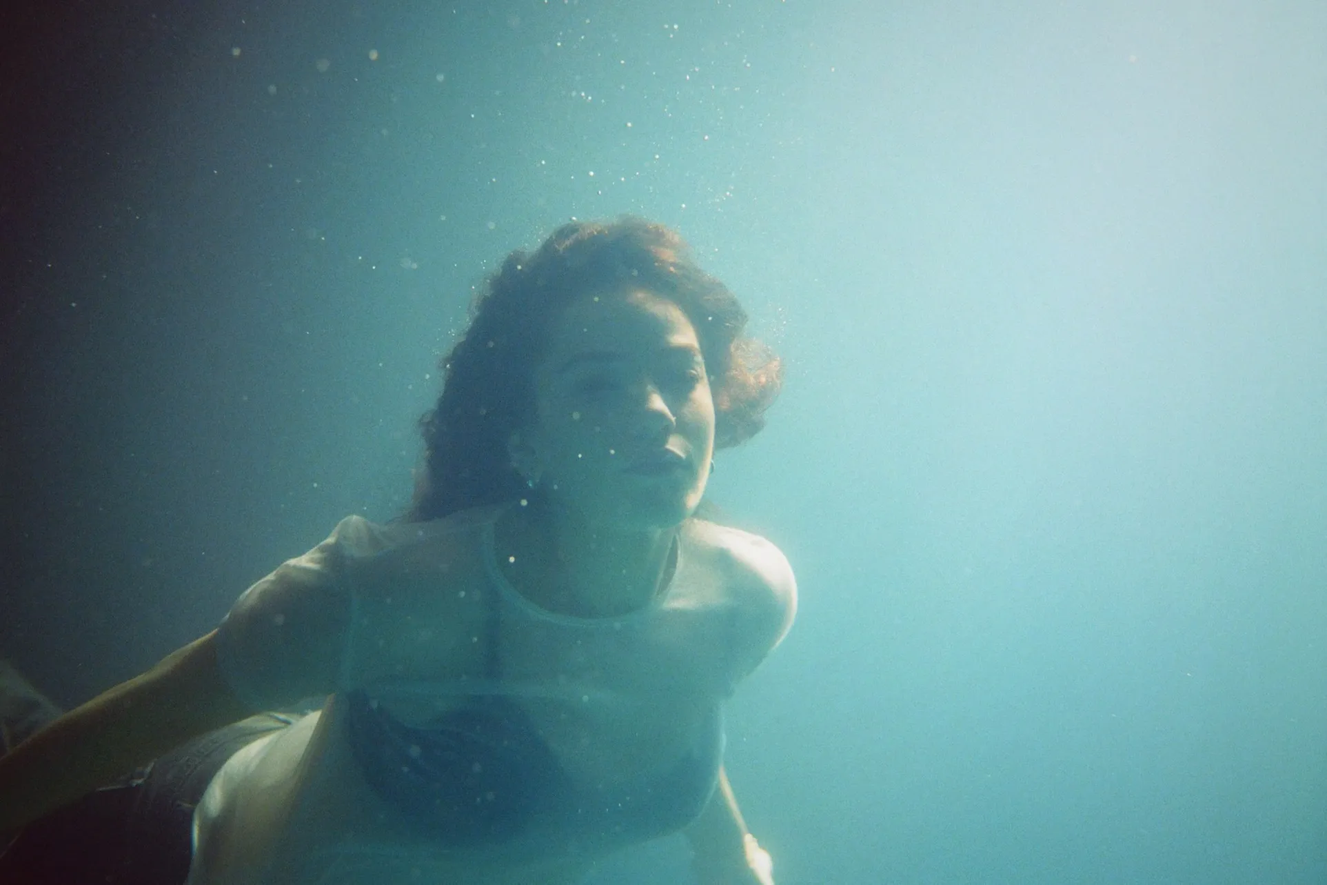 Talia Rae immerses herself in a surreal underwater world with her new 'Rocket Woman' video